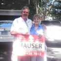 Hauser Contractors clients in front of sign