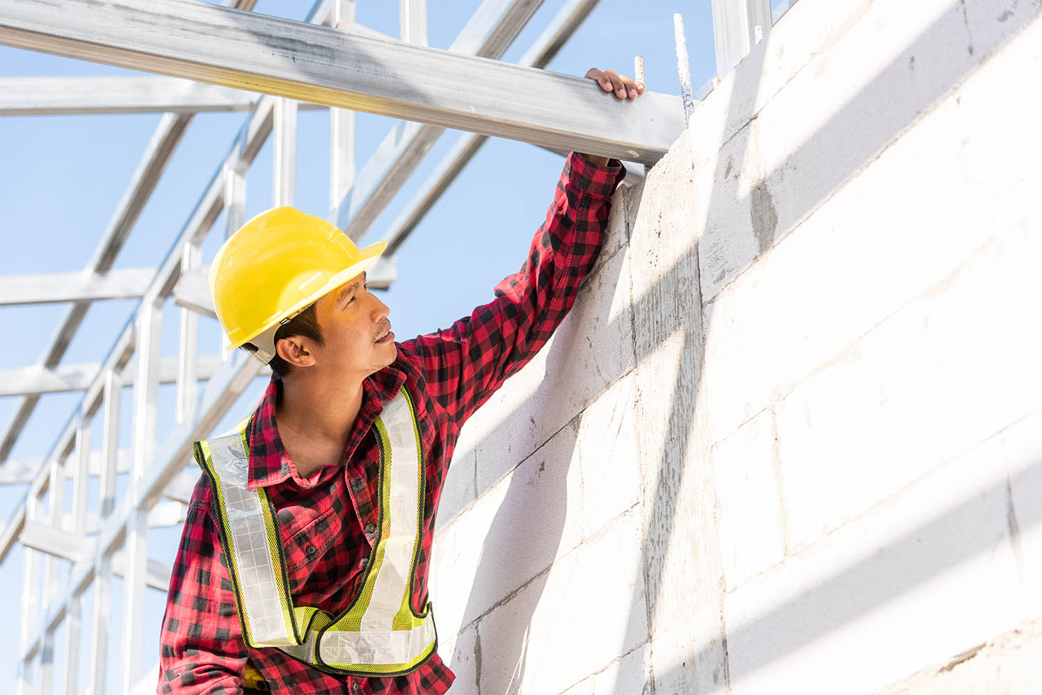 worker is constructing roof of the house worker is constructing roof