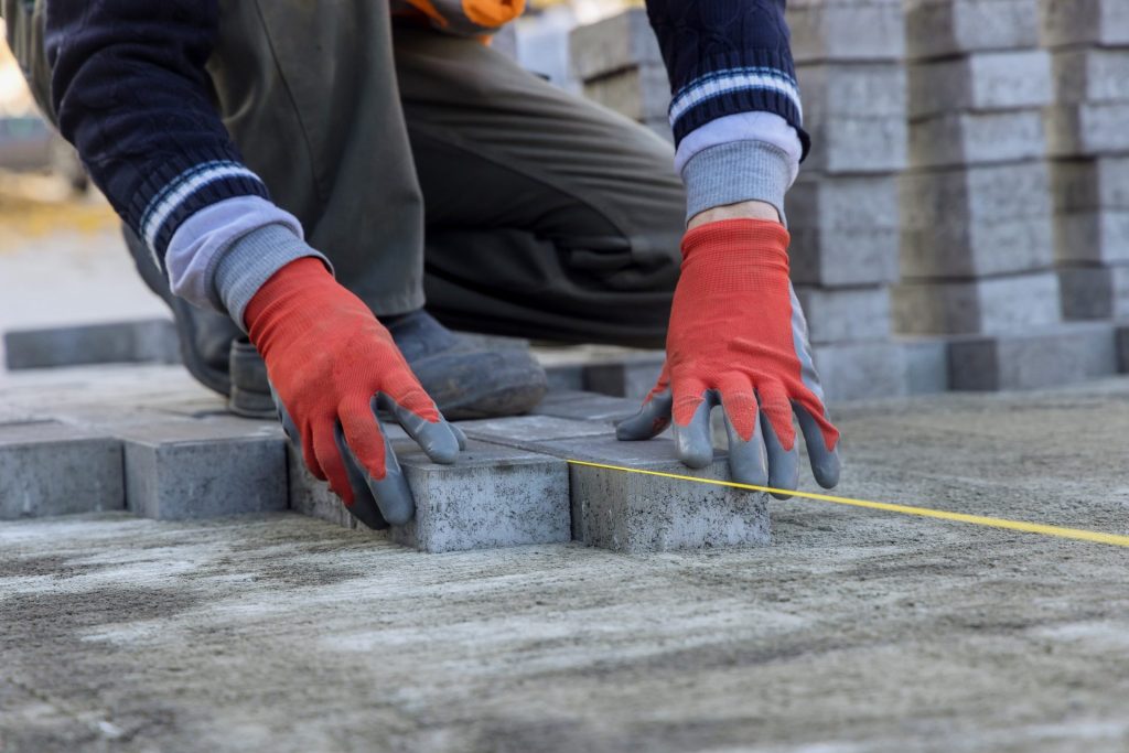 Contractor installing pavers